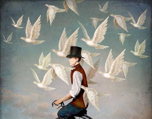 mies kyyhkysten ympäröimänä